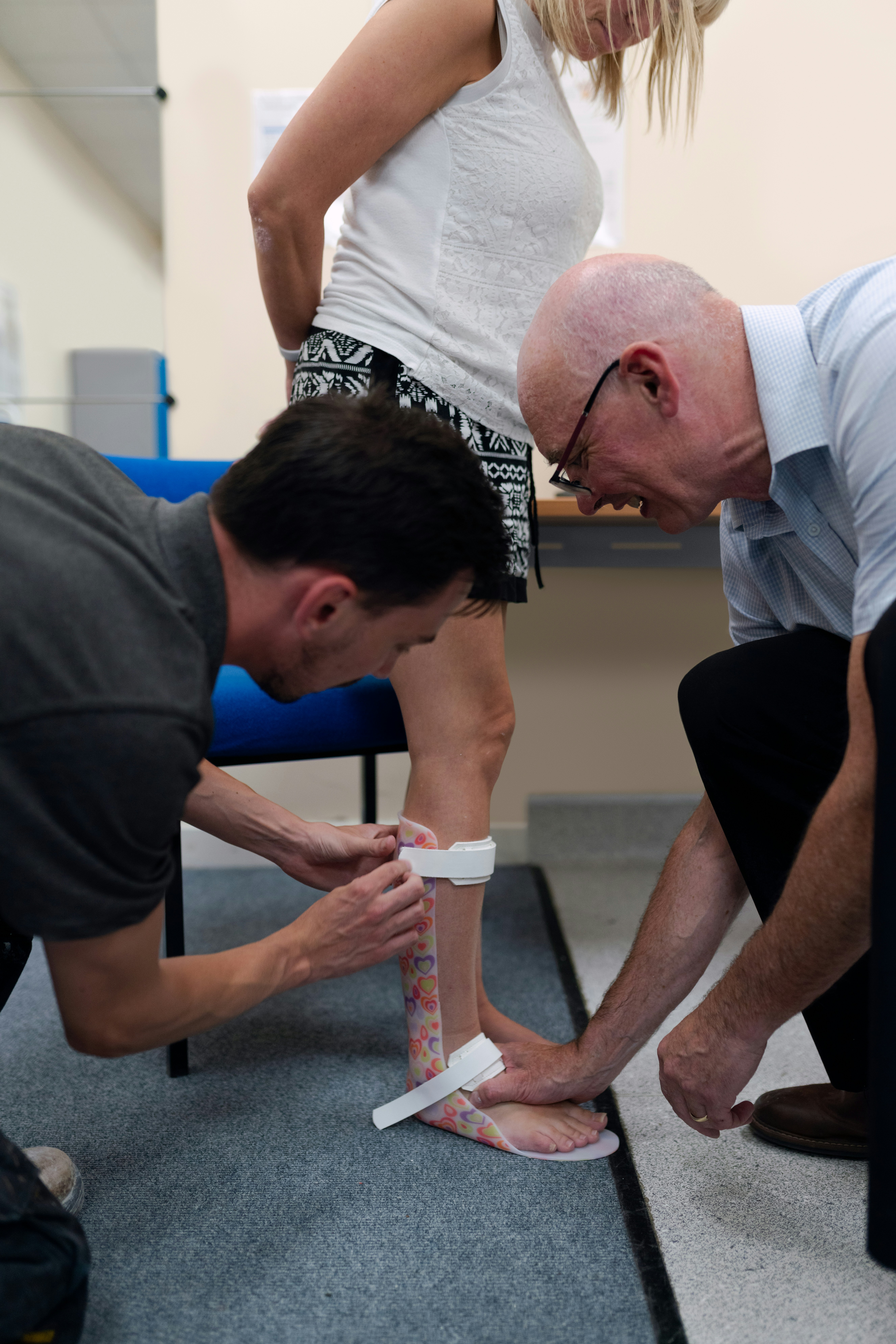 Male orthotic technician engineer fits personalised leg splint